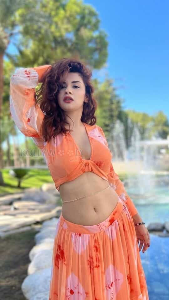 Cute Avneet Kaur Showing Navel in an Orange Dress Photos 01