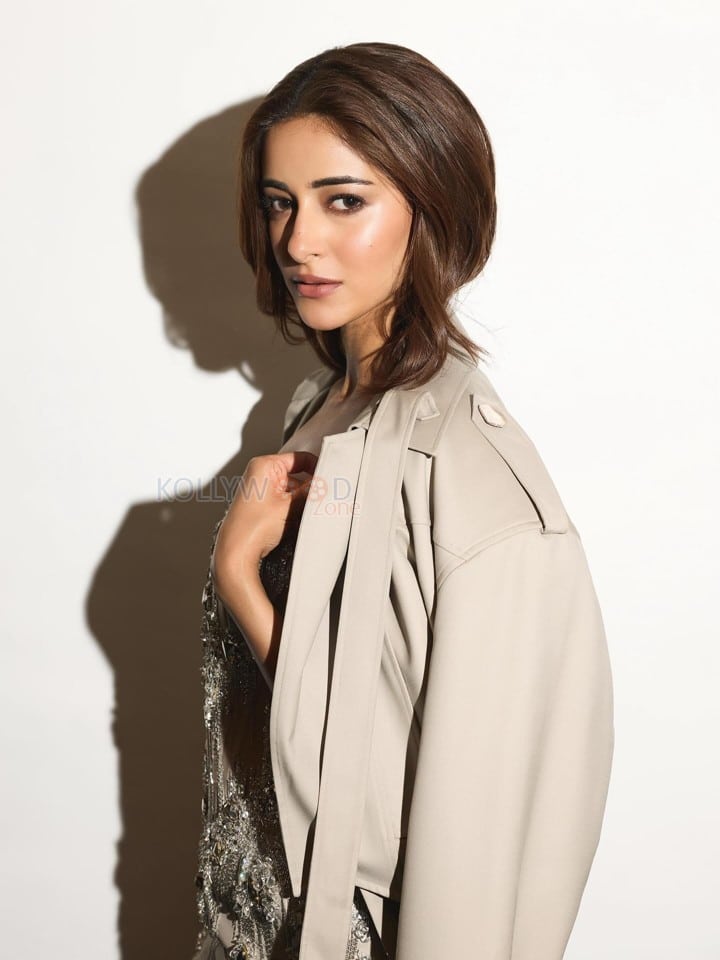 Actress Ananya Panday in an Embellished Corset Midi Dress with a Light Brown Trench Coat Pictures 02
