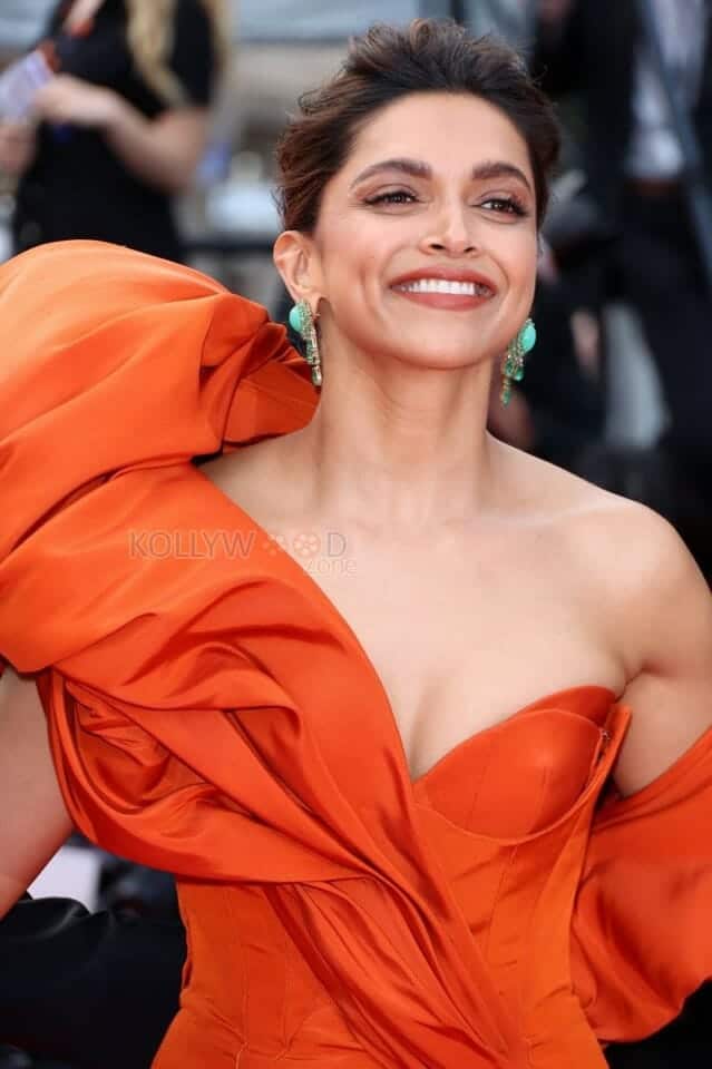 Actress Deepika Padukone wearing a Red Gown and Showing Cleavage Photo 01