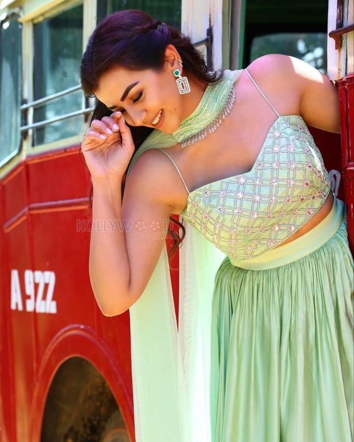 Actress Nikki Galrani in a Light Green Lehenga Set on a Red Bus Photos 04