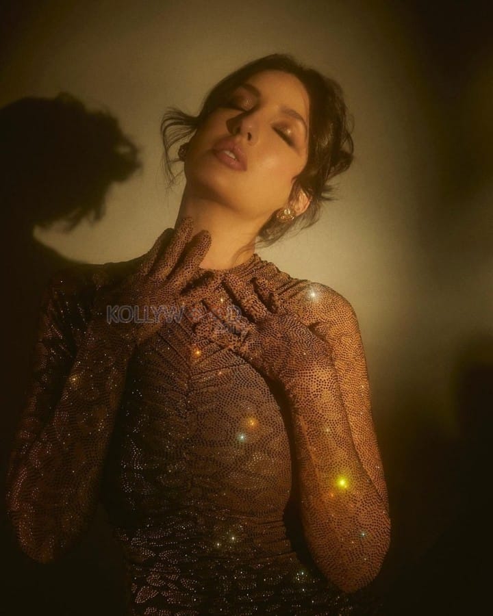 Actress Nora Fatehi in a Gold Bodycon Sparkly Dress Photos 02