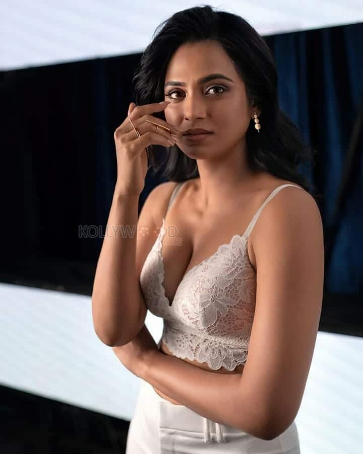 Actress Ramya Pandian in a White Elegant Sexy Bralette Photos 03