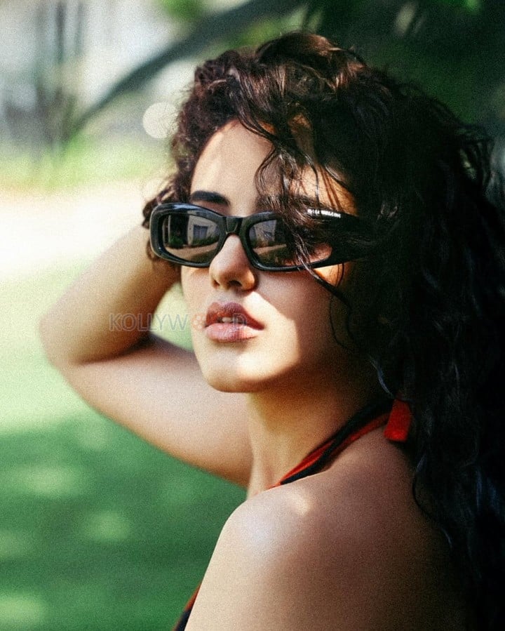 Bold and Hot Malvika Sharma in an Orange Bralette and Black Shorts Photos 03