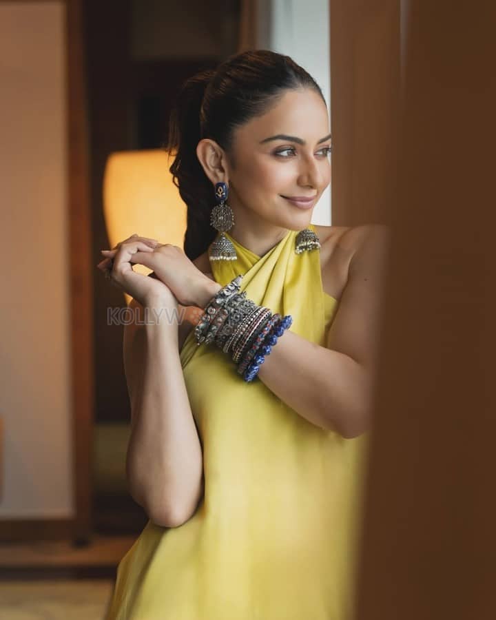 Bollywood Diva Rakul Preet Singh in a Yellow Backless Top and Wide Legged Pants Photos 02