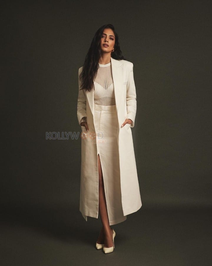 Classy Malavika Mohanan in an Off White Long Coat and Thigh Slit Skirt Photos 05