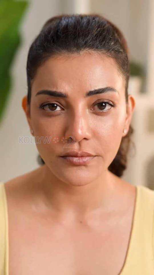 Elegant Kajal Aggarwal in a Yellow Buttoned Up Sleeveless Top and Blue Denim Pants Photos 02