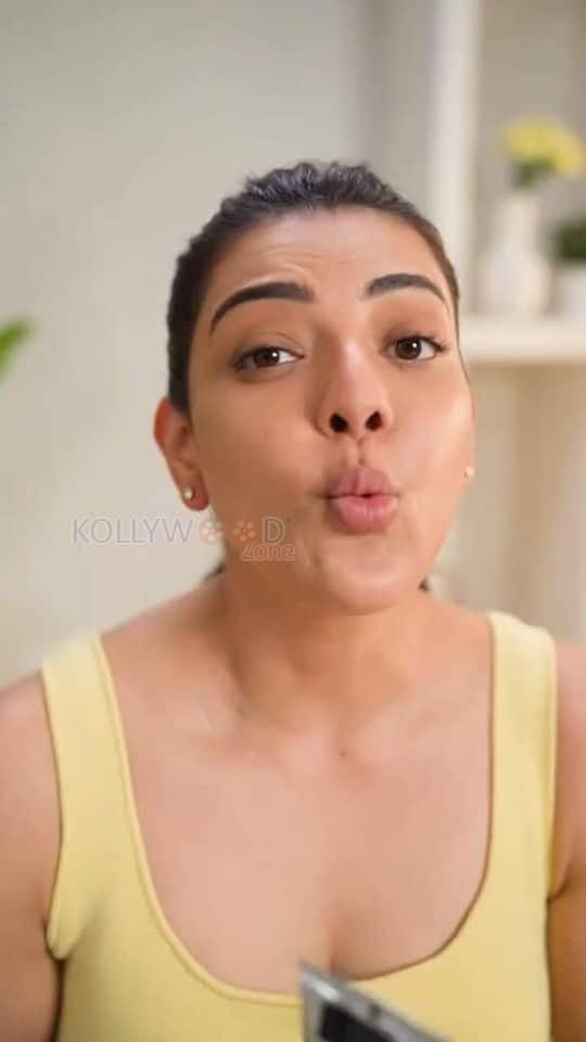 Elegant Kajal Aggarwal in a Yellow Buttoned Up Sleeveless Top and Blue Denim Pants Photos 03
