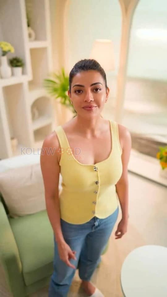Elegant Kajal Aggarwal in a Yellow Buttoned Up Sleeveless Top and Blue Denim Pants Photos 04