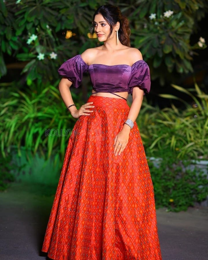 Elegant Payal Rajput in a Purple Off Shoulder Crop Top and Red Lehenga Photos 01