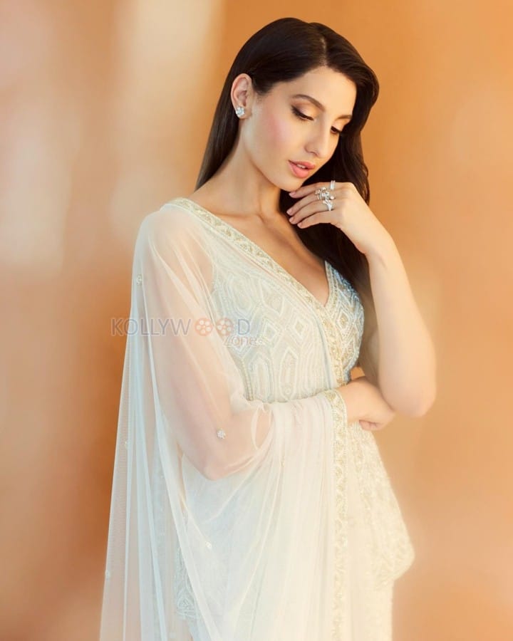 Enchanting Nora Fatehi in a Ivory Net Embroidered Bead Plunge V Geometric Short Kurta Sharara Set Photos 02