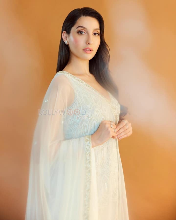 Enchanting Nora Fatehi in a Ivory Net Embroidered Bead Plunge V Geometric Short Kurta Sharara Set Photos 03