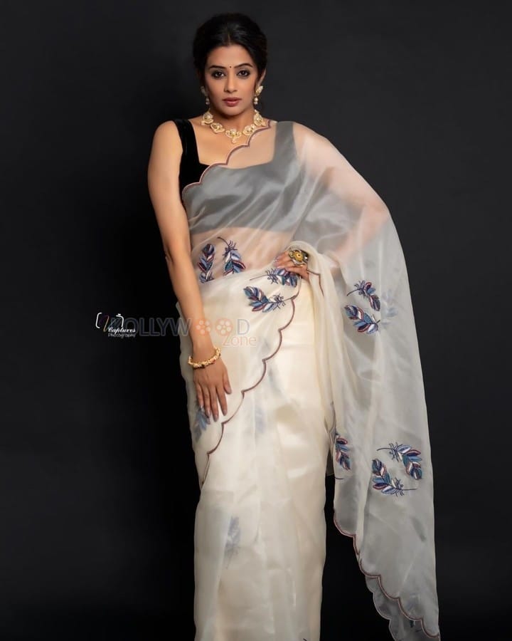 Glamorous Priyamani in a White Transparent Saree with Black Sleeveless Blouse Pictures 02