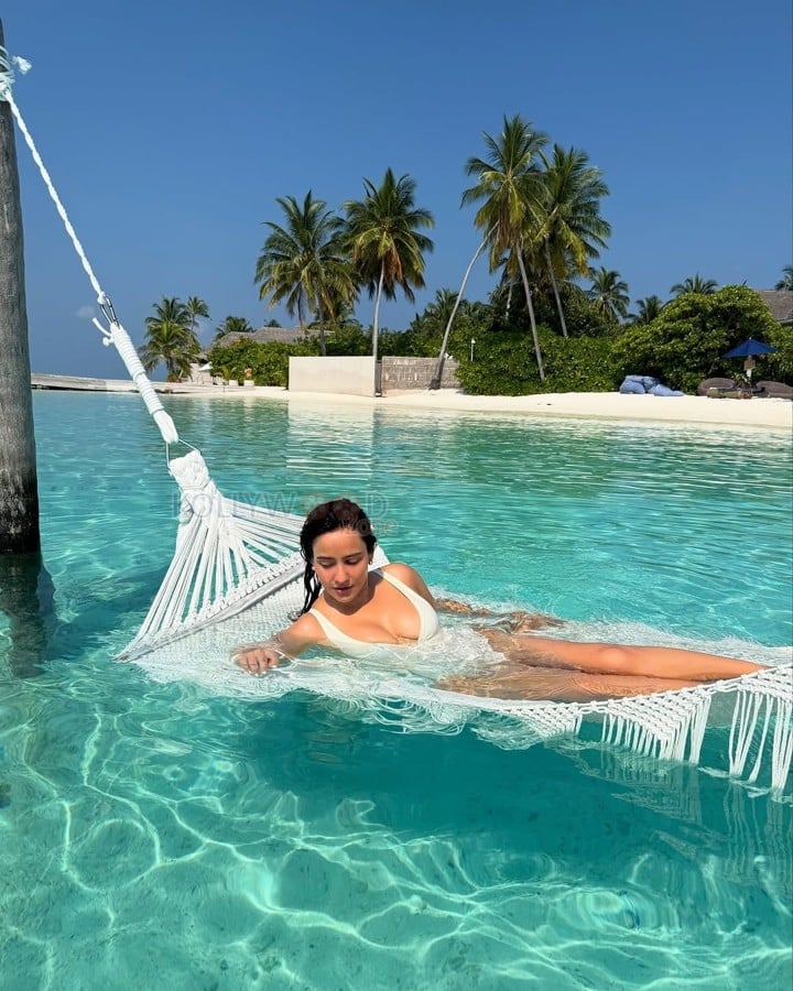 Hot Glam Neha Sharma in a White Cleavage Swimsuit at Maldives Photos 03