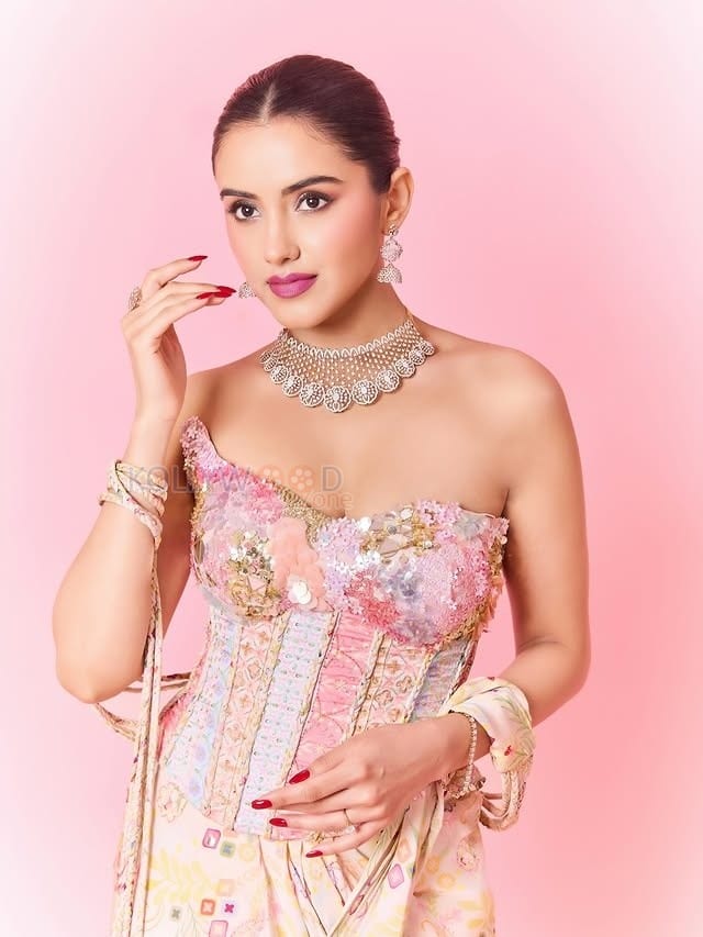 Hot Malvika Sharma in a Pastel Pink Sequined Embroidered Corset Top with Floral Embellishments and Pre Draped Saree Pictures 06