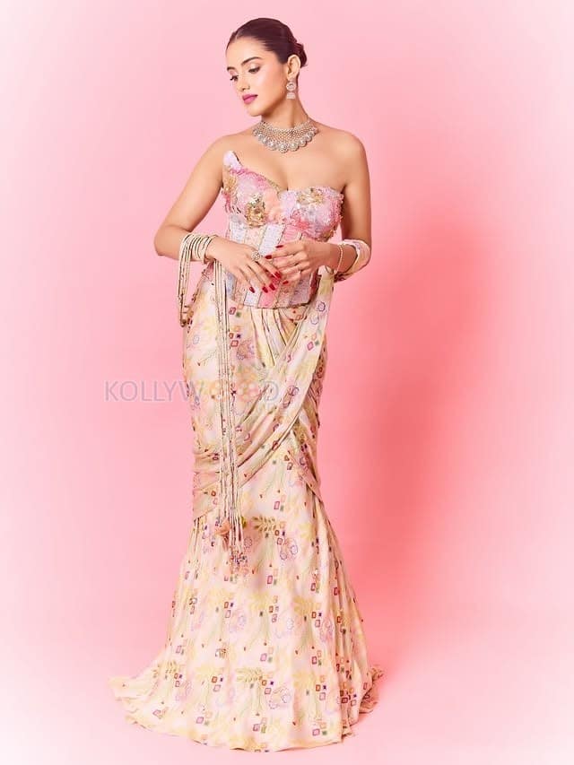 Hot Malvika Sharma in a Pastel Pink Sequined Embroidered Corset Top with Floral Embellishments and Pre Draped Saree Pictures 08