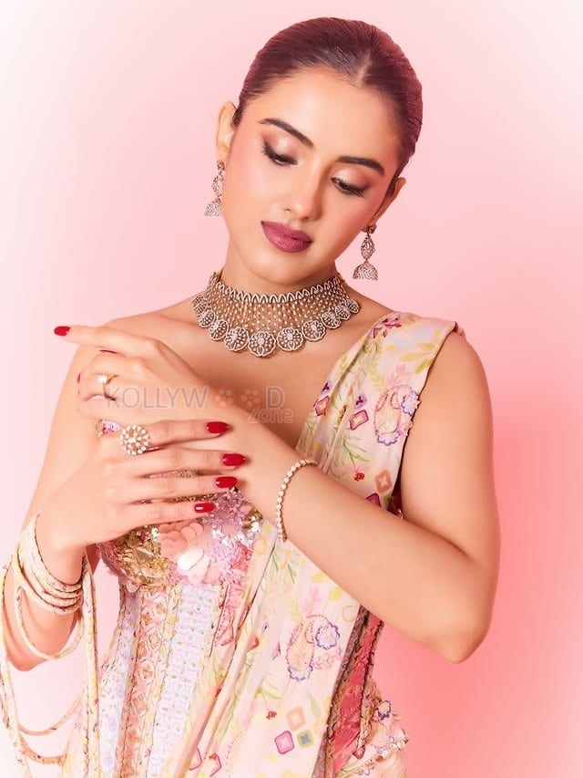 Hot Malvika Sharma in a Pastel Pink Sequined Embroidered Corset Top with Floral Embellishments and Pre Draped Saree Pictures 09