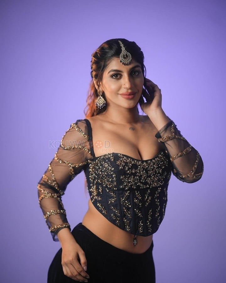 Hot Yashika Aannand in a Black Embroidered Netted Sleeve Top with a Black Skirt Photos 01