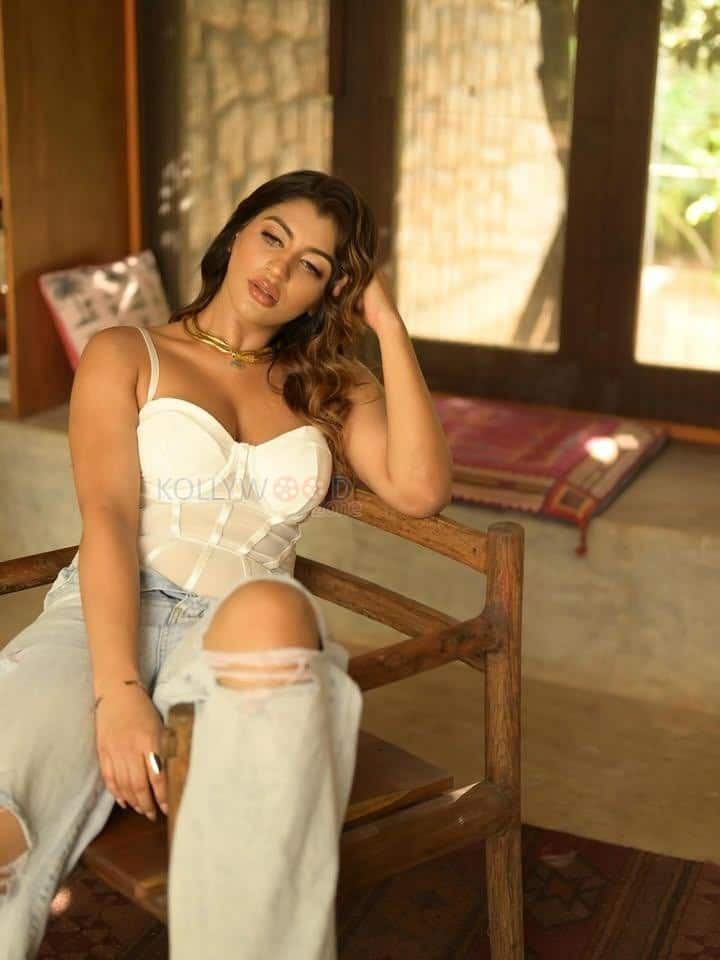 Hot Yashika Aannand in a White Corset Style Sleeveless Top and Light Blue Torn Jeans Photos 03