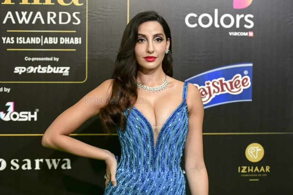 Nora Fatehi Showing Cleavage in a Blue Dress 01