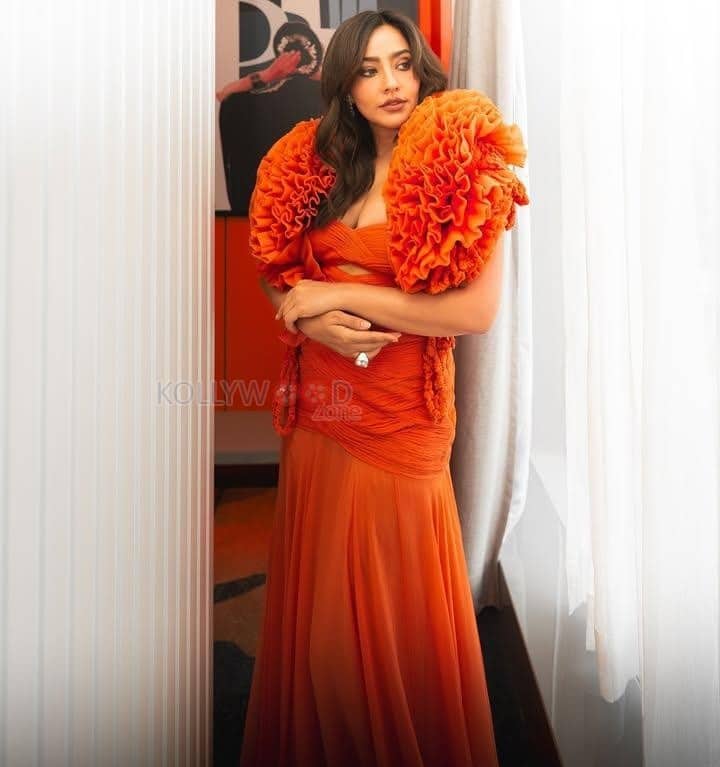 Sensual Neha Sharma in an Orange Floor Length Gown with a Bold Cleavage Cut Out Photos 03