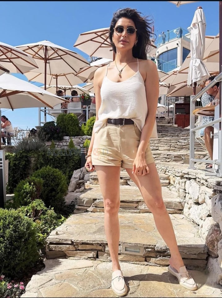 Sexy Karishma Tanna in a Light Beige Camisole Top with a High Waist Khaki Shorts Photos 02