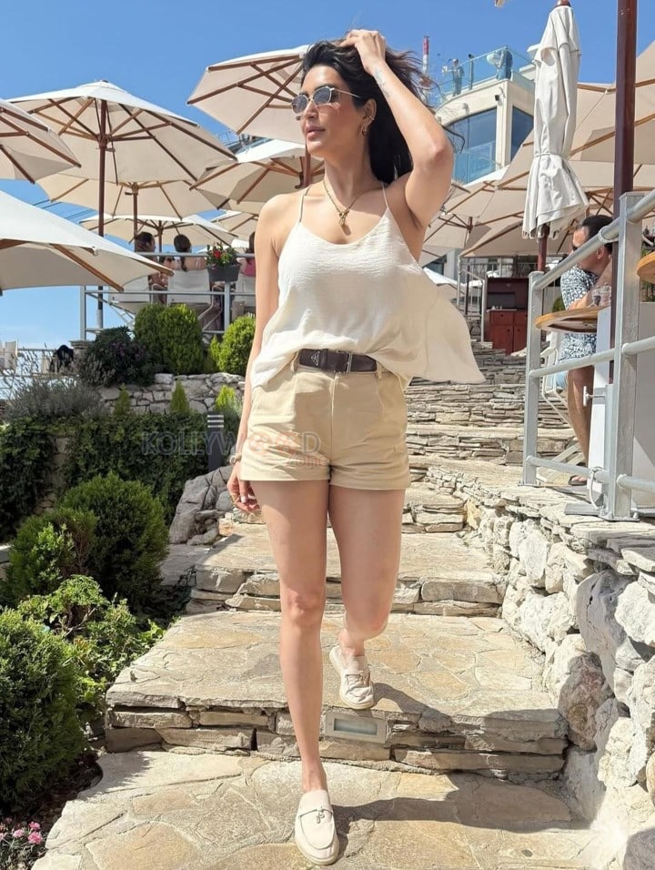 Sexy Karishma Tanna in a Light Beige Camisole Top with a High Waist Khaki Shorts Photos 03