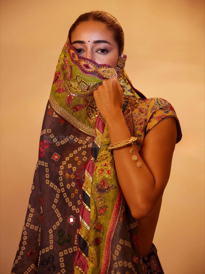 Stunning Ananya Panday in a Black Hand Embroidered Lehenga with a High Neck Mustard Yellow Blouse Photos 04