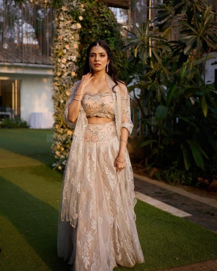 The Raja Saab Heroine Malavika Mohanan in a Cream Lehenga with an Off Shoulder Top and Midi Coat Dupatta Photos 03