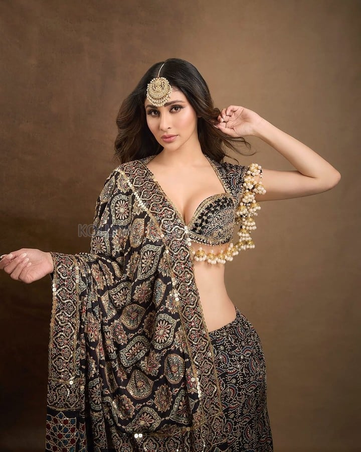 Dazzling Mouni Roy in a Black and Gold Lehenga Choli Photos 02