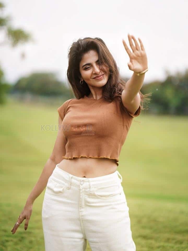 Desirable Iswarya Menon in a Brown Crop Top and White Denim Pants Photos 02