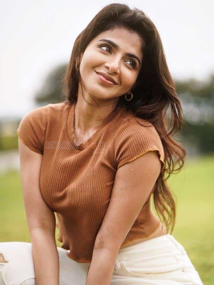 Desirable Iswarya Menon in a Brown Crop Top and White Denim Pants Photos 03