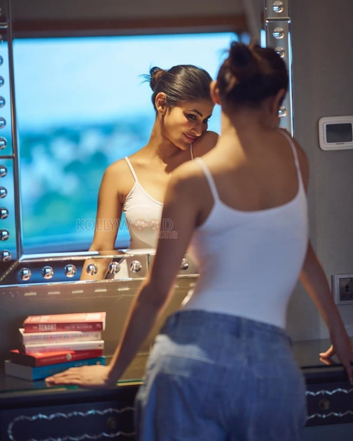Glam Mouni Roy in a White Tank Top and Blue Denim Photos 03