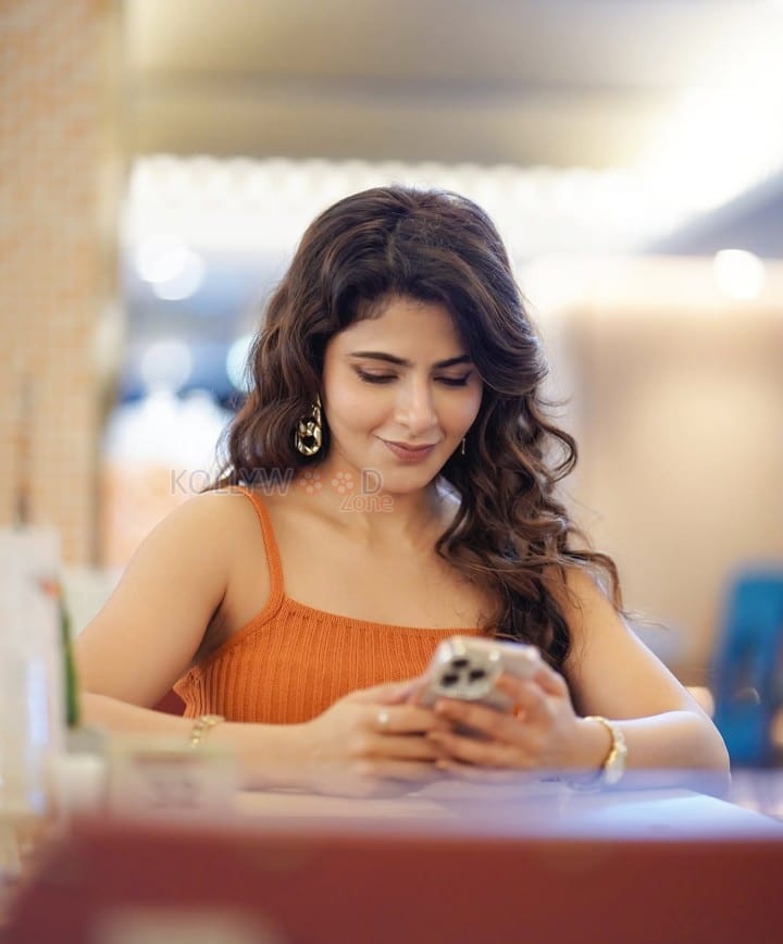Stylish Iswarya Menon in an Orange Ribbed Crop Top with a High Waisted Blue Jeans Photos 02