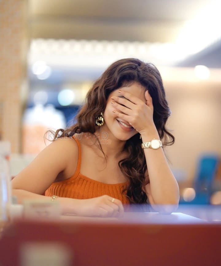 Stylish Iswarya Menon in an Orange Ribbed Crop Top with a High Waisted Blue Jeans Photos 04