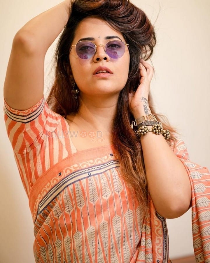 Tollywood Beauty Anasuya Bharadwaj in an Orange Saree and Puple Sunglass Photos 03