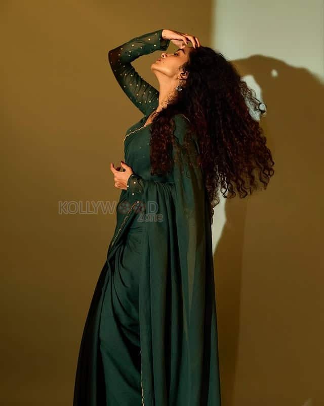 Beautifully Gorgeous Anupama Parameswaran in a Green Saree with Sheer Full Sleeve Blouse Photos 02