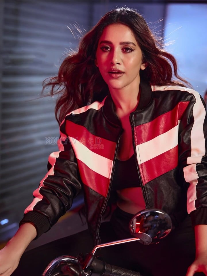 Biker Beauty Nabha Natesh in a Stylish Black Red and White Leather Jacket with a Black Sports Bra and Black Pant Photos 04