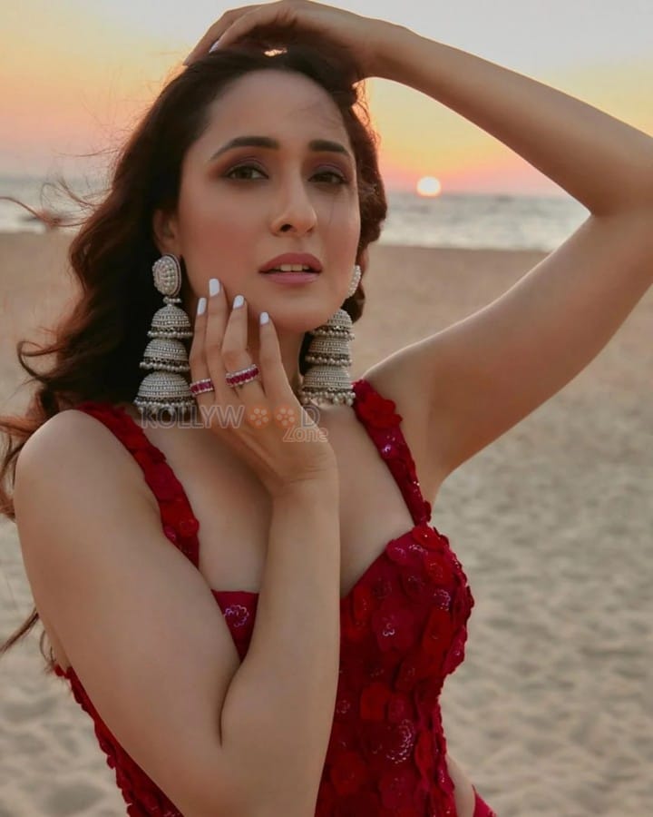 Stylish Pragya Jaiswal in a Red Dress at the Beach Photos 02