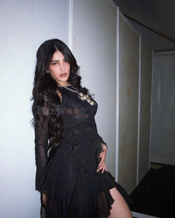 Fashionista Shruti Haasan in a Black Ruffle Maxi Dress with Thigh High Boots Photos 06