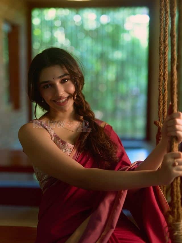 Beautiful Telugu Actress Krithi Shetty in a Maroon Red Silk Saree with a Cream Sleeveless Blouse Pictures 01