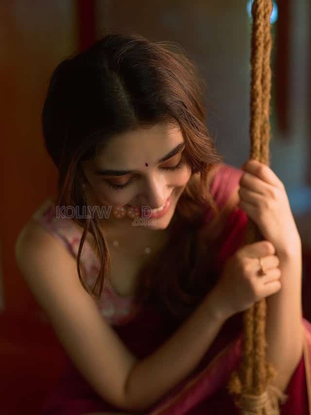 Beautiful Telugu Actress Krithi Shetty in a Maroon Red Silk Saree with a Cream Sleeveless Blouse Pictures 03