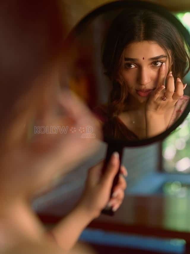 Beautiful Telugu Actress Krithi Shetty in a Maroon Red Silk Saree with a Cream Sleeveless Blouse Pictures 05