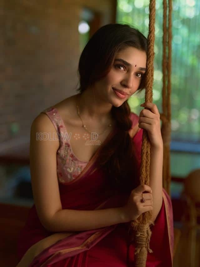 Beautiful Telugu Actress Krithi Shetty in a Maroon Red Silk Saree with a Cream Sleeveless Blouse Pictures 08