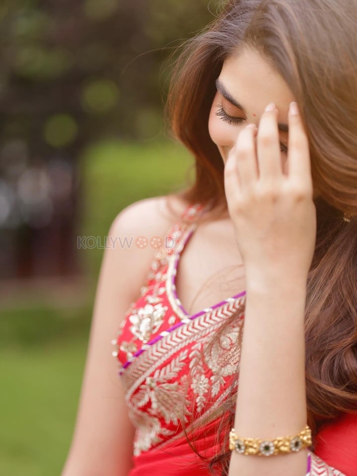 Cute Actress Krithi Shetty in a Vibrant Red Saree with Gold and Red Border Pictures 02
