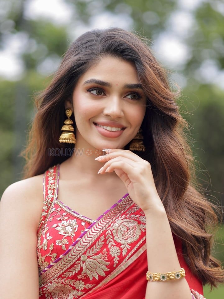 Cute Actress Krithi Shetty in a Vibrant Red Saree with Gold and Red Border Pictures 03