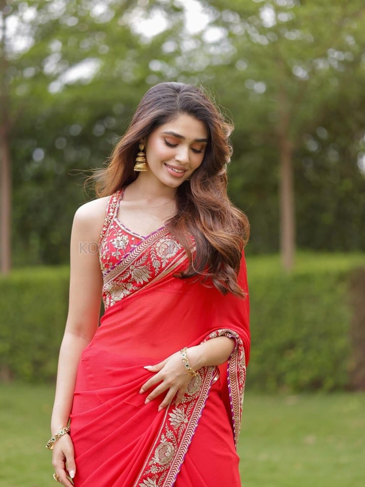 Cute Actress Krithi Shetty in a Vibrant Red Saree with Gold and Red Border Pictures 06