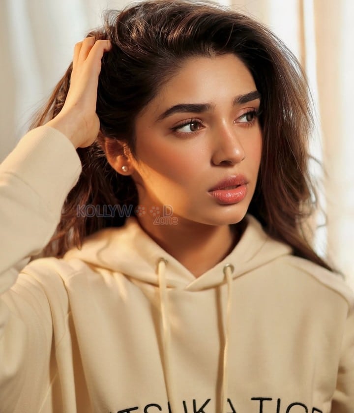 Sexy and Hot Krithi Shetty in a Cream Hoodie with a Blue Denim Mini Shorts Photos 03