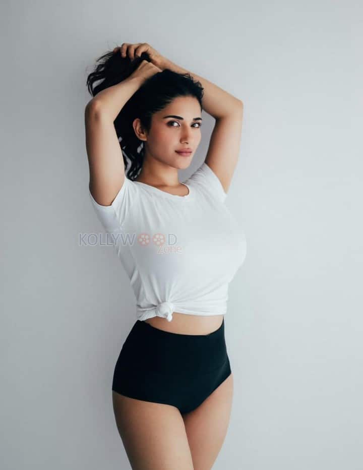 Charming Beauty Ruhani Sharma in a White Knotted T Shirt with a High Waisted Black Mini Shorts Photos 03