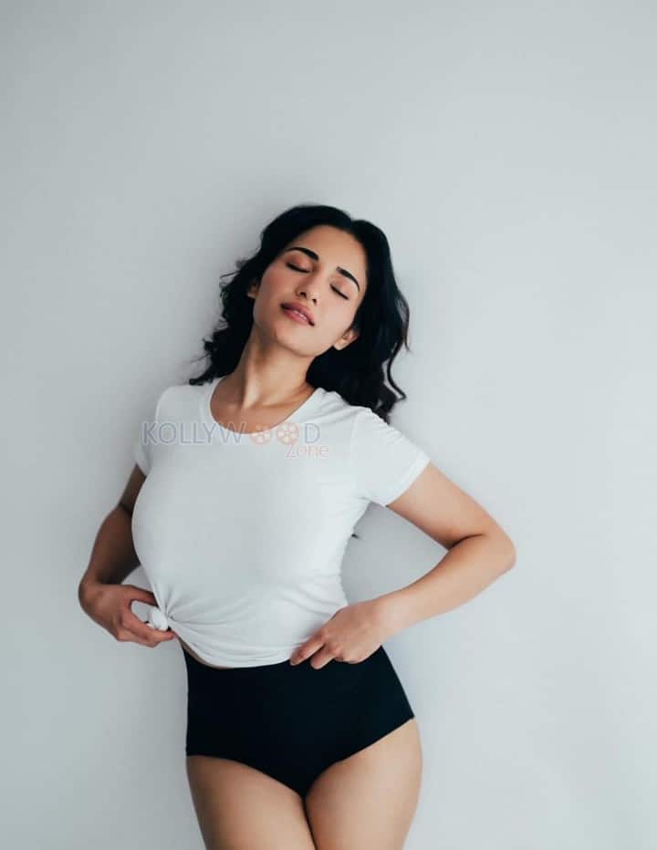 Charming Beauty Ruhani Sharma in a White Knotted T Shirt with a High Waisted Black Mini Shorts Photos 04