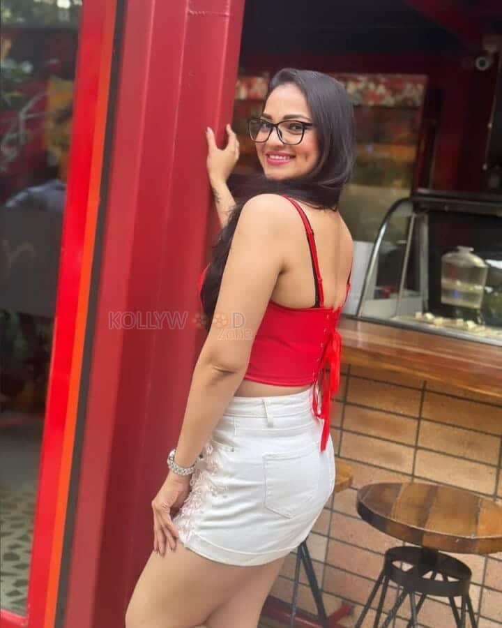 Actress Ashwini Sri in a Mini Red Top and White Shorts Photos 06